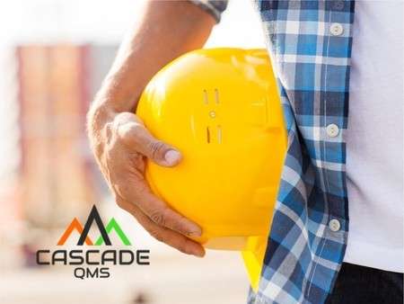 Contractor with hard hat at side and Cascade QMS logo.