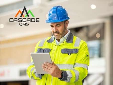 Safety Manager looking at checklist with Cascade QMS logo.