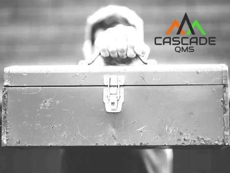 Toolbox being held with a Cascade QMS logo.