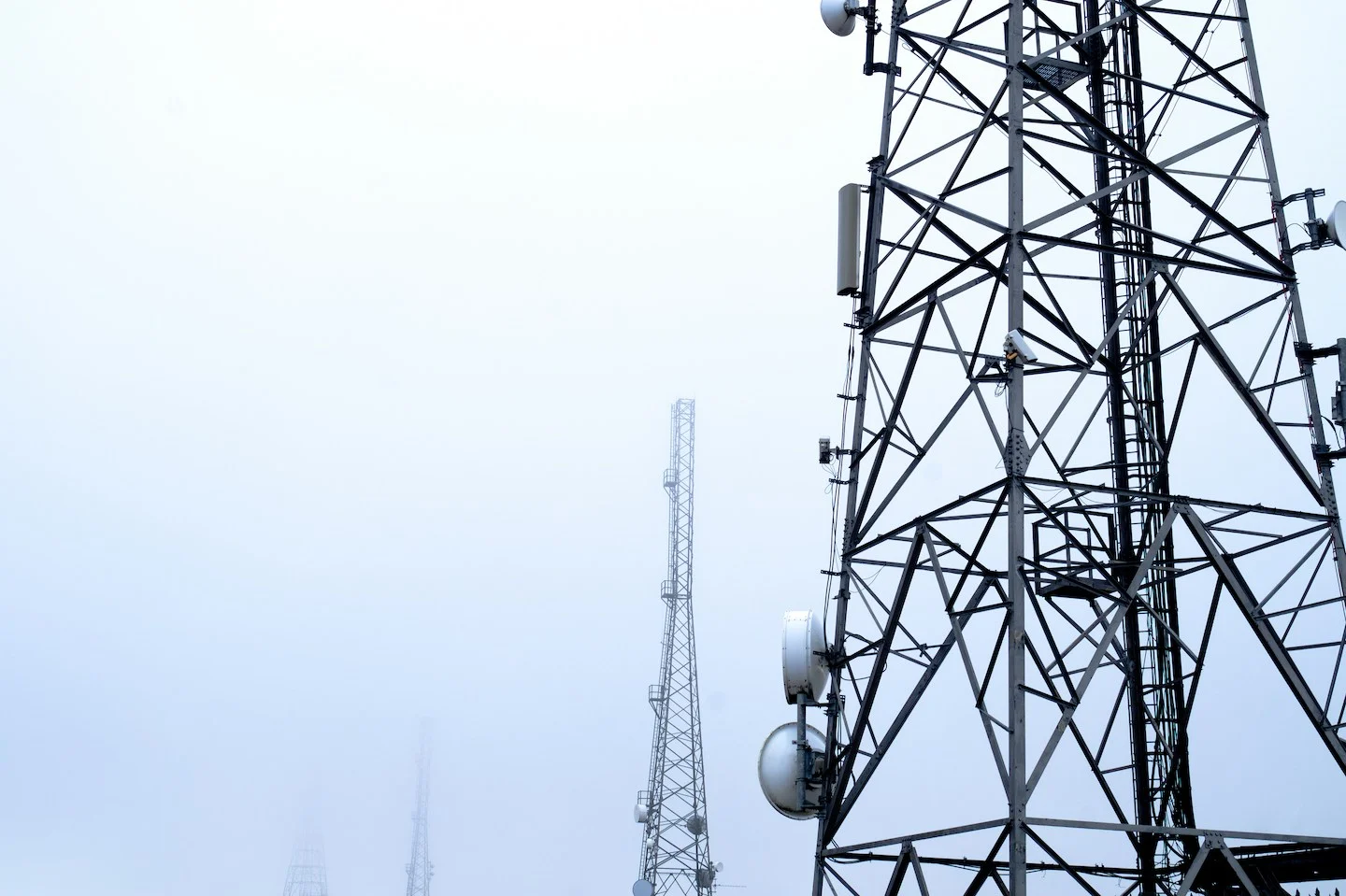 Telecommunication towers in foggy weather.