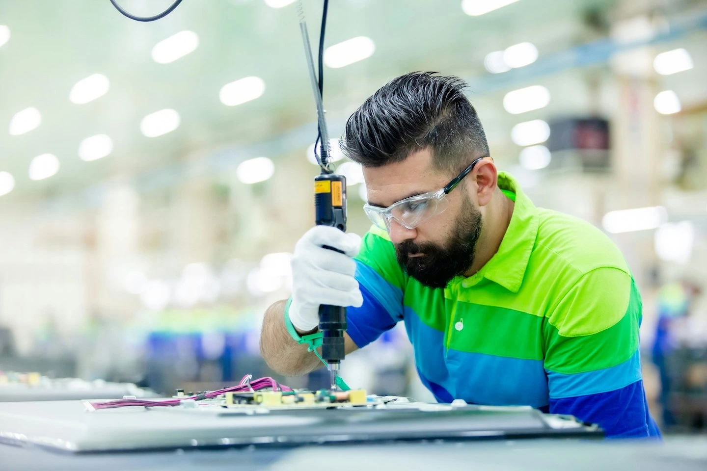 Manufacturing contractor using machine to construct electrical equipment.