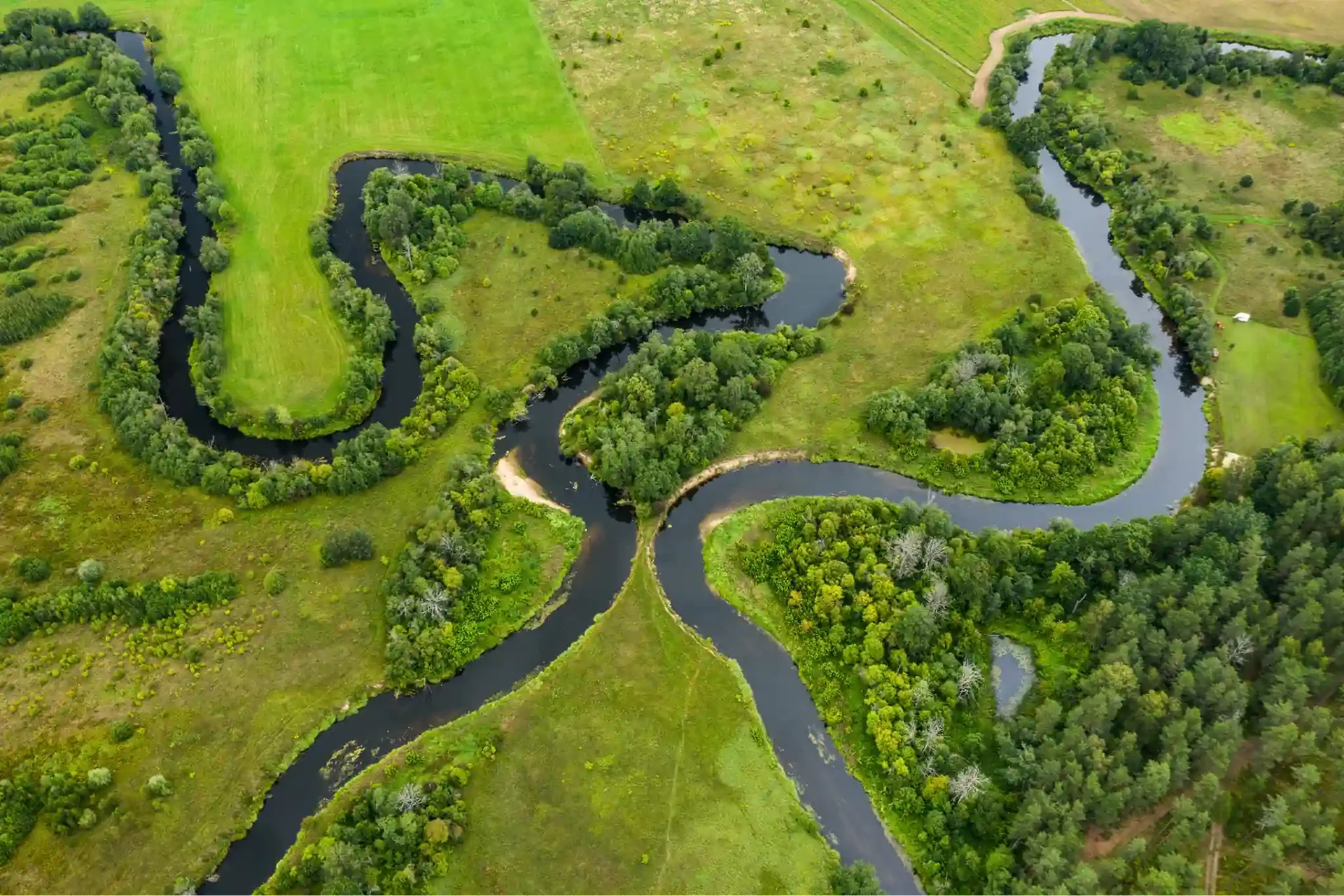 Aerial view of grassy plains and winding river.
