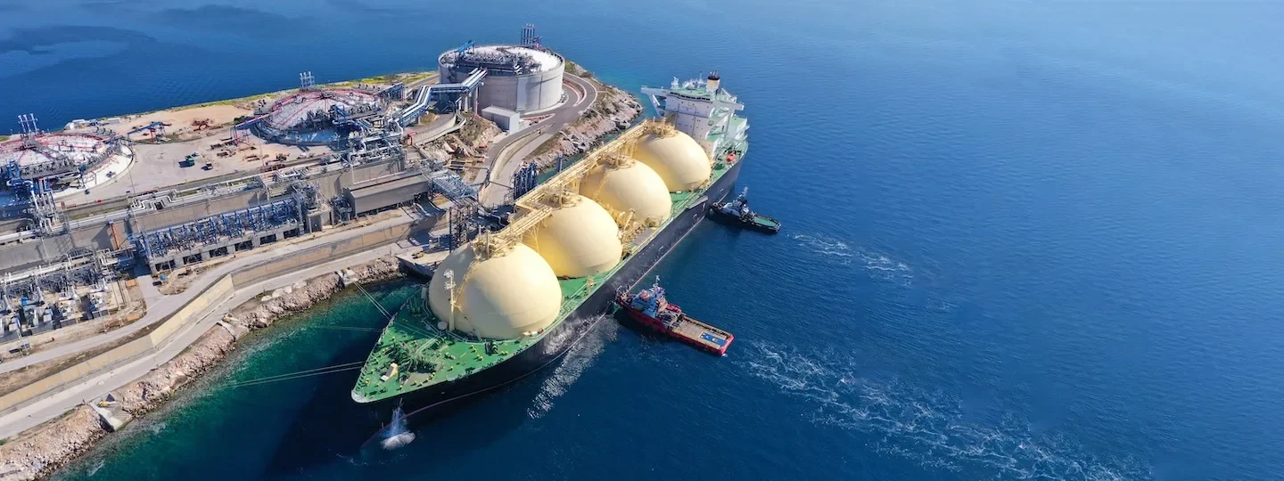 LNG tanker at small terminal island with tanks