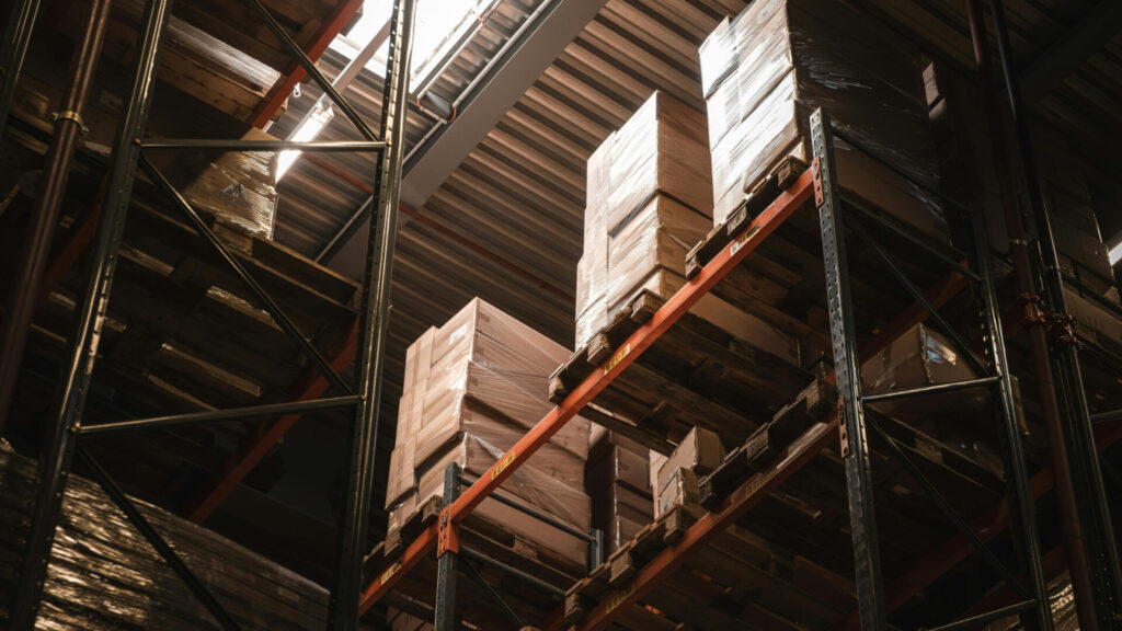 boxes stacked on shelves in a warehouse that looks like Amazon