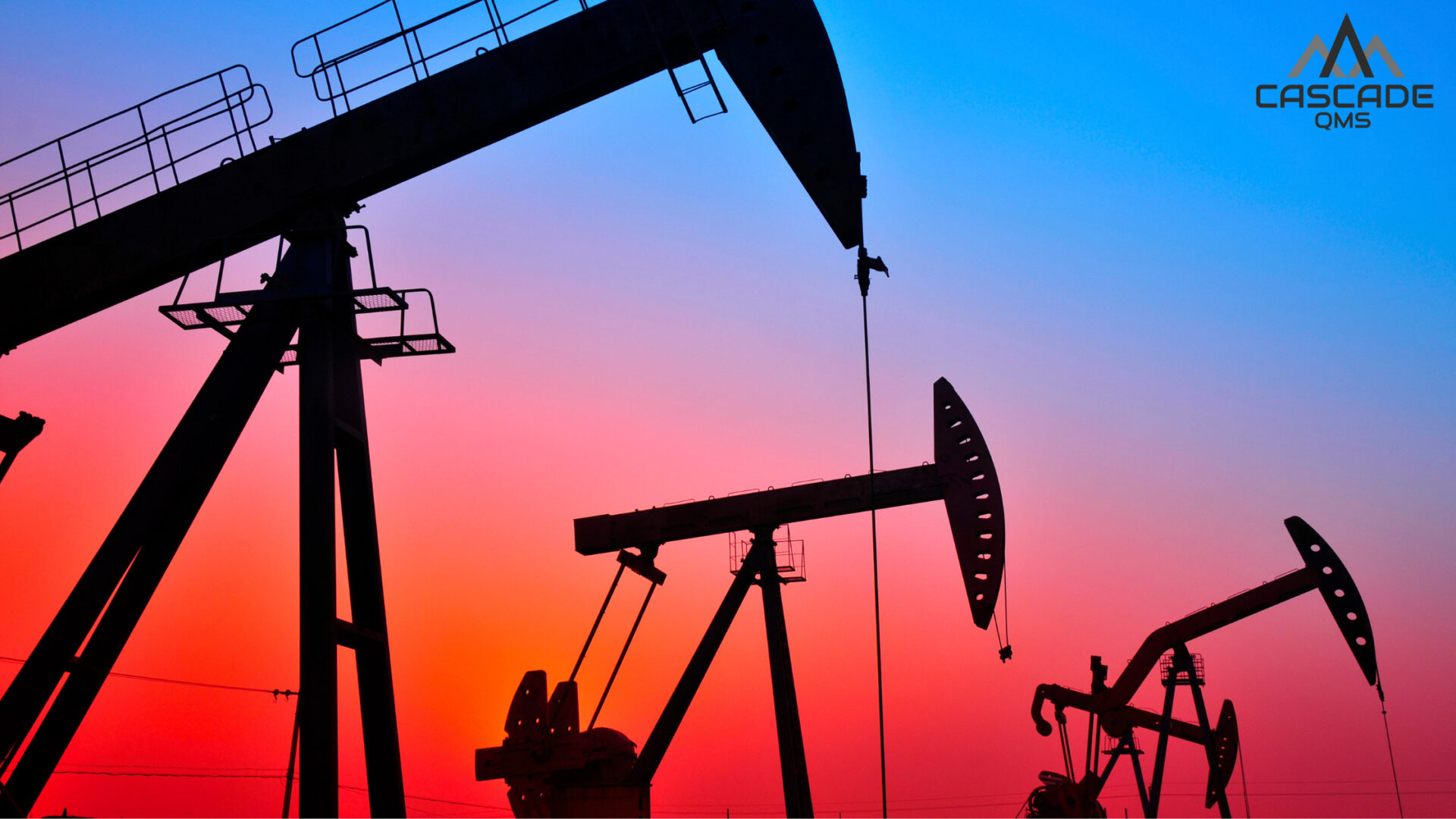 Oil pumpjacks silhouetted against a vibrant sunset, symbolizing Chord Energy’s commitment to safe, compliant operations through ISNetworld certification.