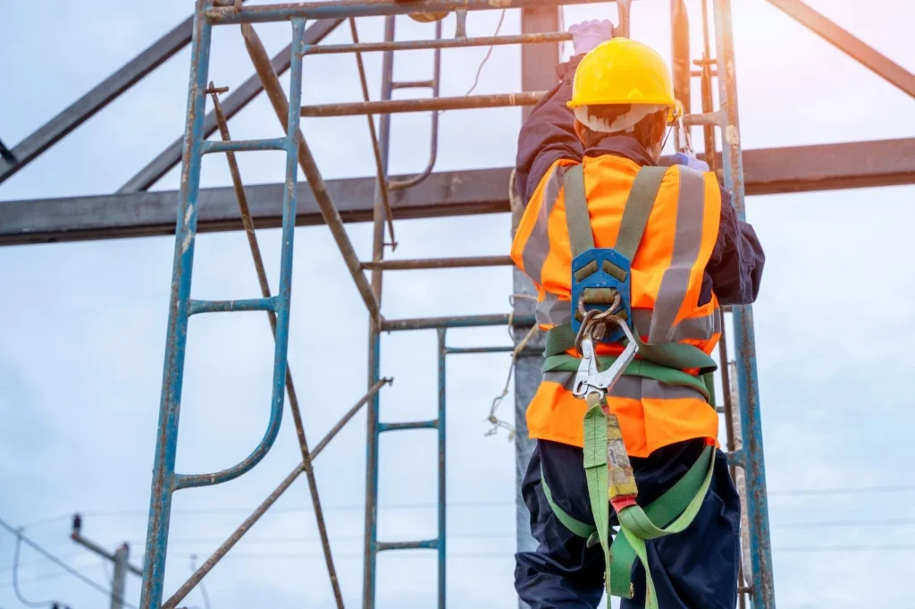 Man climbing tower under guidance of fall protection safety program.