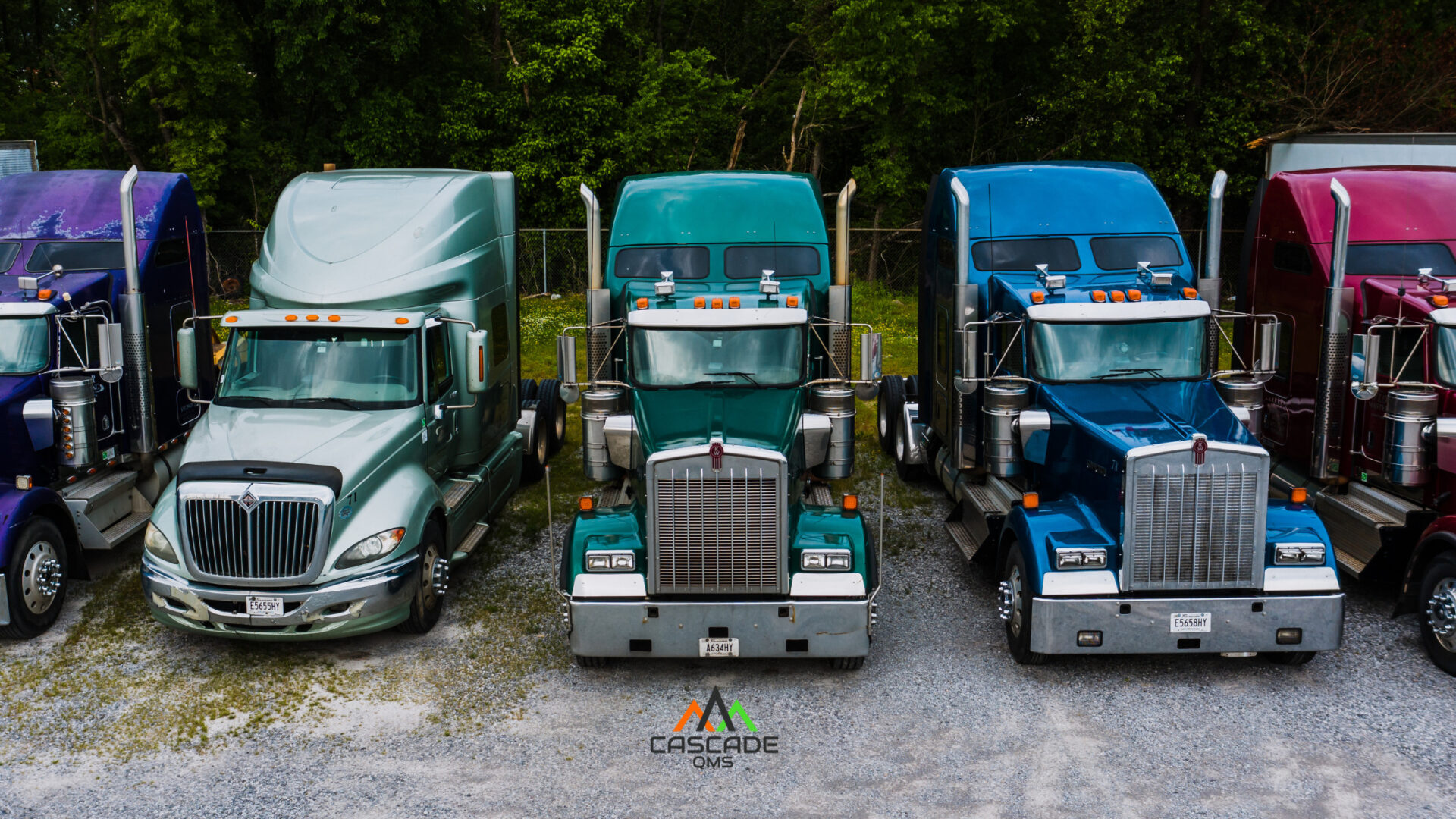 Trucks lined up ready ful or trucking and hauling oil and gas with cascade qms logo