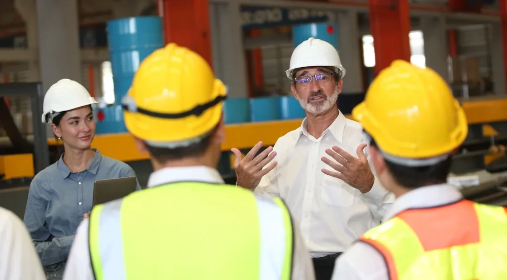 Project manager gives Toolbox Safety Talk to team before the shift begins.