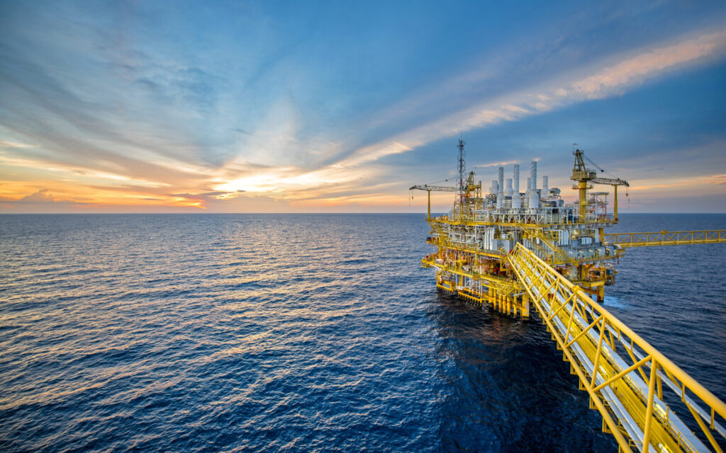 Offshore oil rig during sunset.